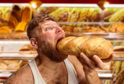 37626700-closeup-of-a-man-eating-bread-in-the-bakery-shop.jpg